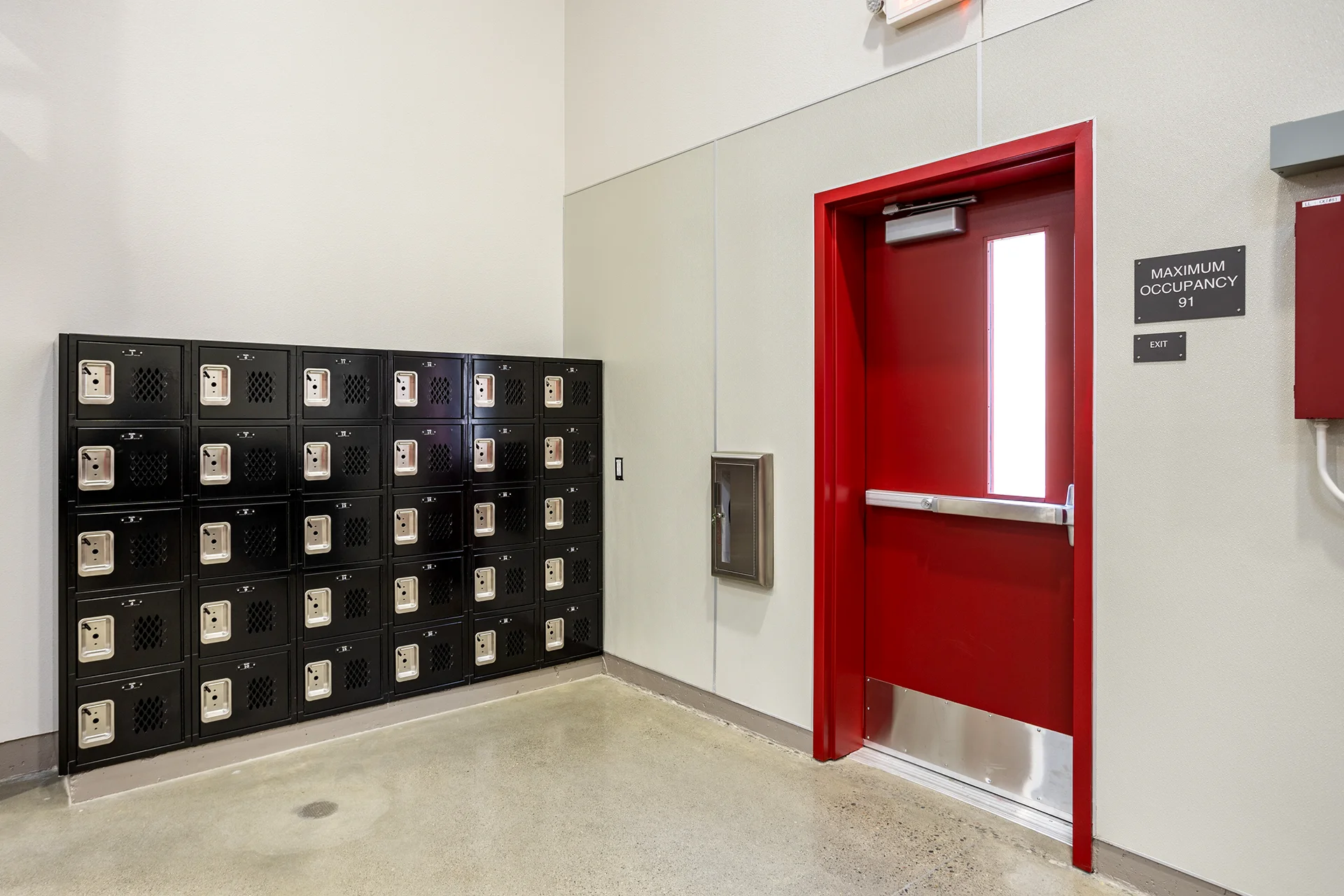 Commercial Entrance with Red Fire Door and Storage Lockers