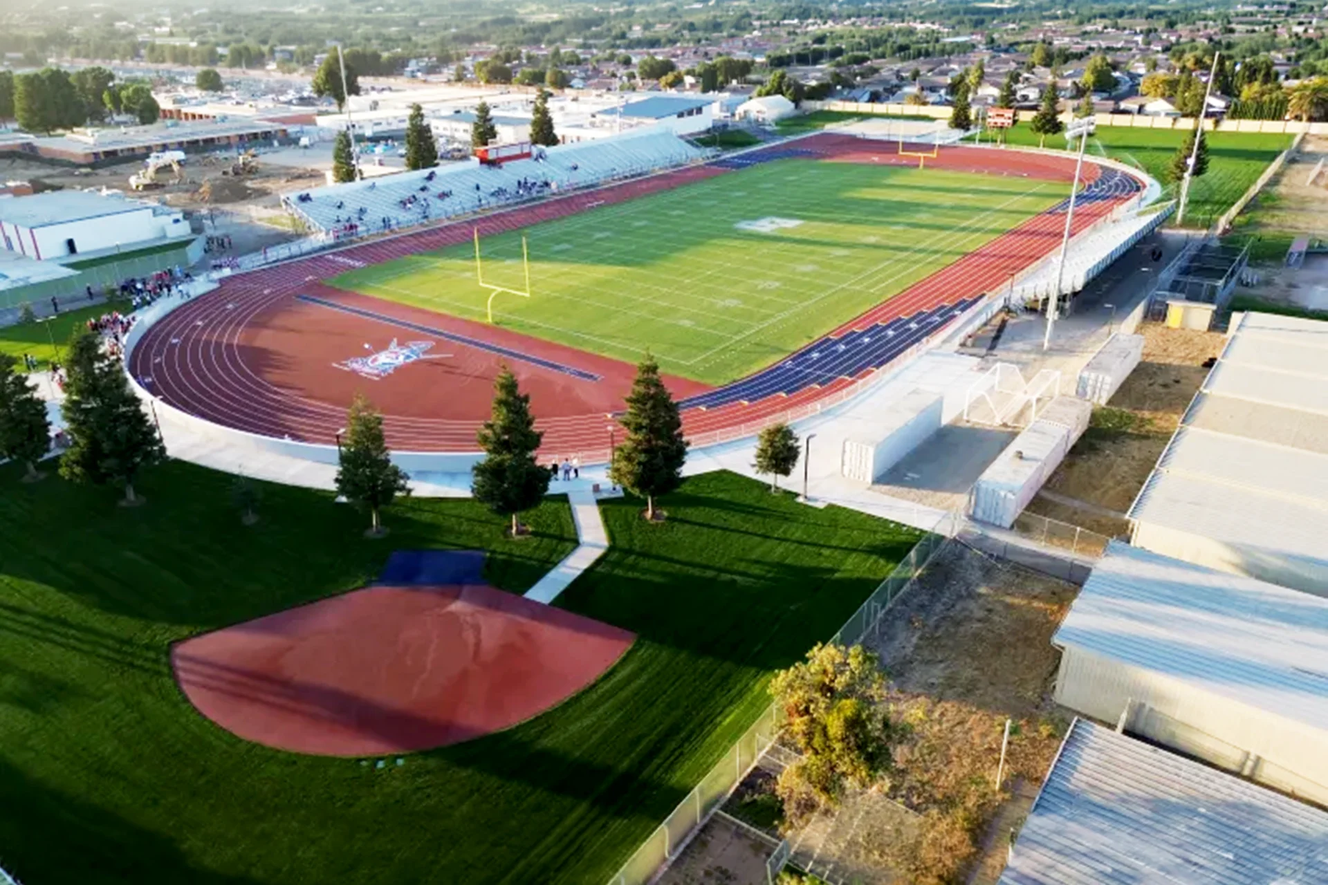 Aerial view of East Union High School’s football stadium, running track, bleachers, and surrounding athletic facilities during an event.