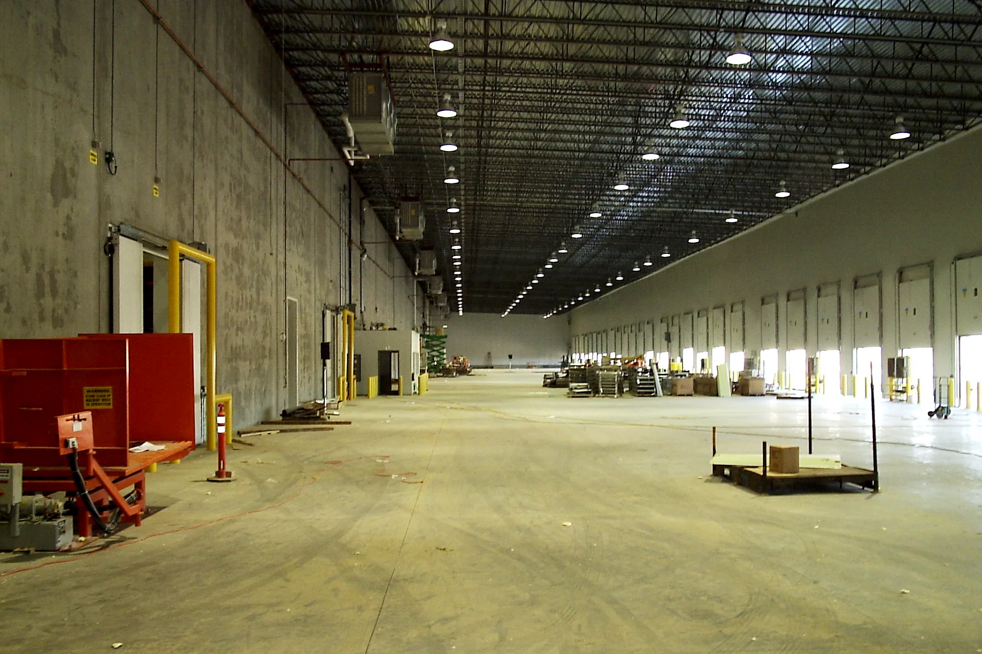 Interior of the Foster Farms distribution warehouse featuring dock doors, loading bays, high-bay lighting, and a spacious logistics staging area.