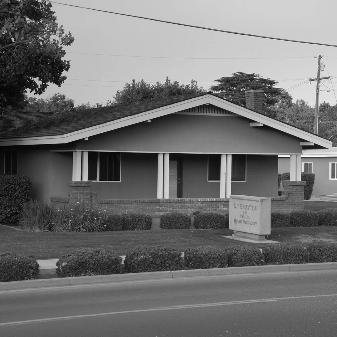 Historic C.T. Brayton & Sons Office Historic black-and-white photograph of the original C.T. Brayton & Sons office building featuring the company monument sign, landscaped grounds, and early headquarters exterior.