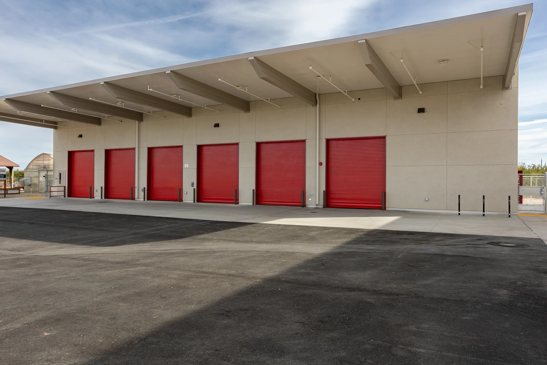 Industrial Warehouse Loading Dock with Red Roll-Up Doors