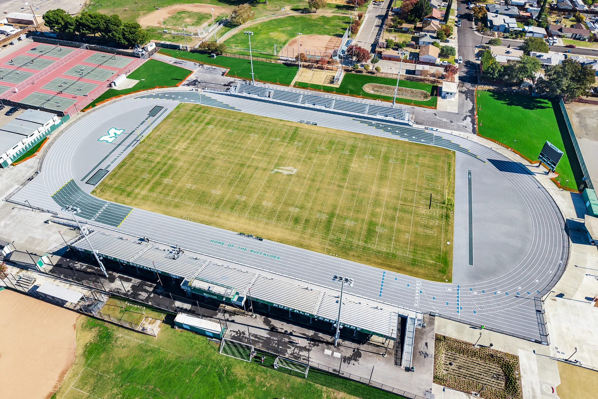 Aerial view of Manteca High School’s football stadium, running track, tennis courts, bleachers, and surrounding athletic facilities after the renovation project.