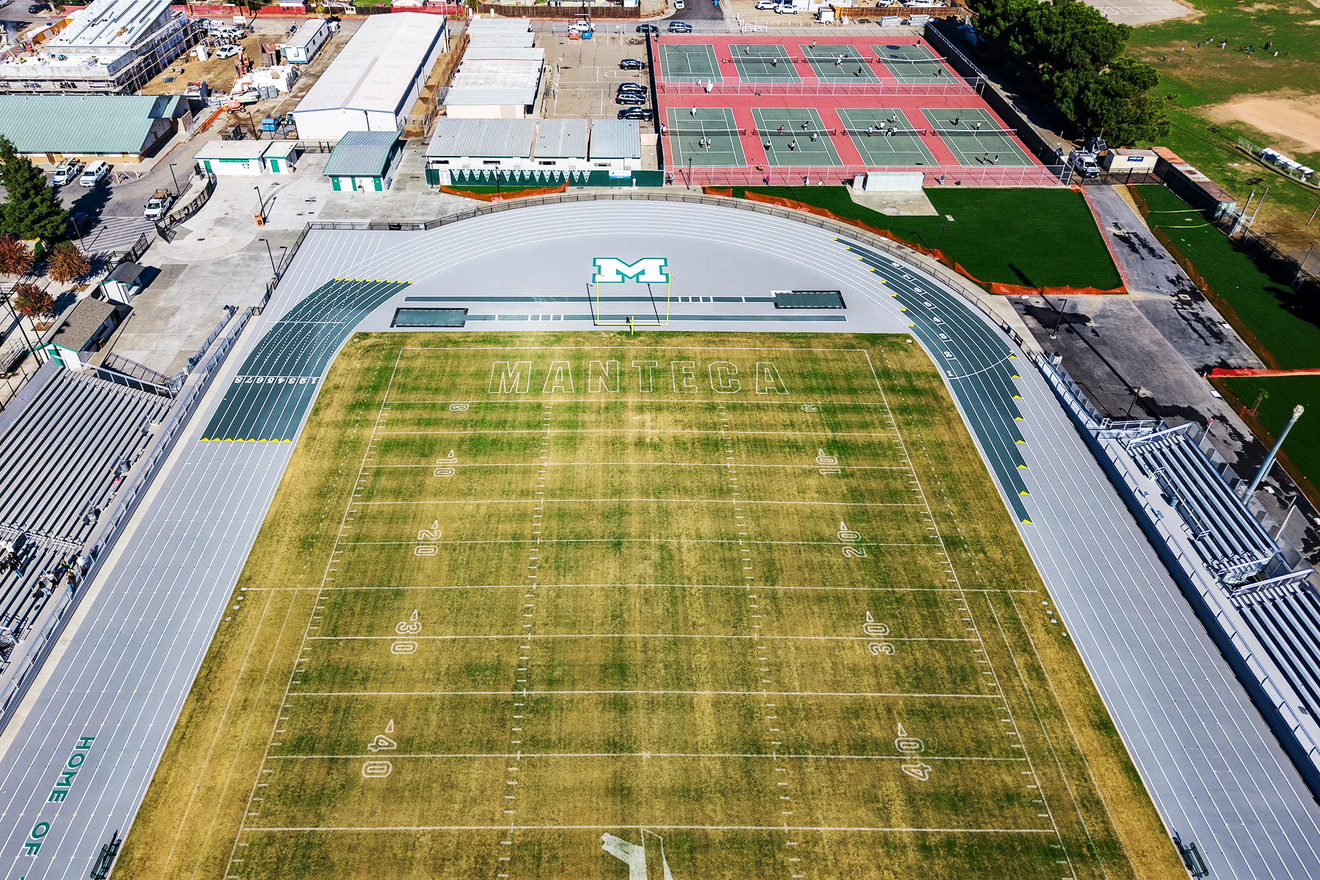 Aerial view of Manteca High School’s football field, running track, tennis courts, and surrounding athletic facilities following the renovation project.