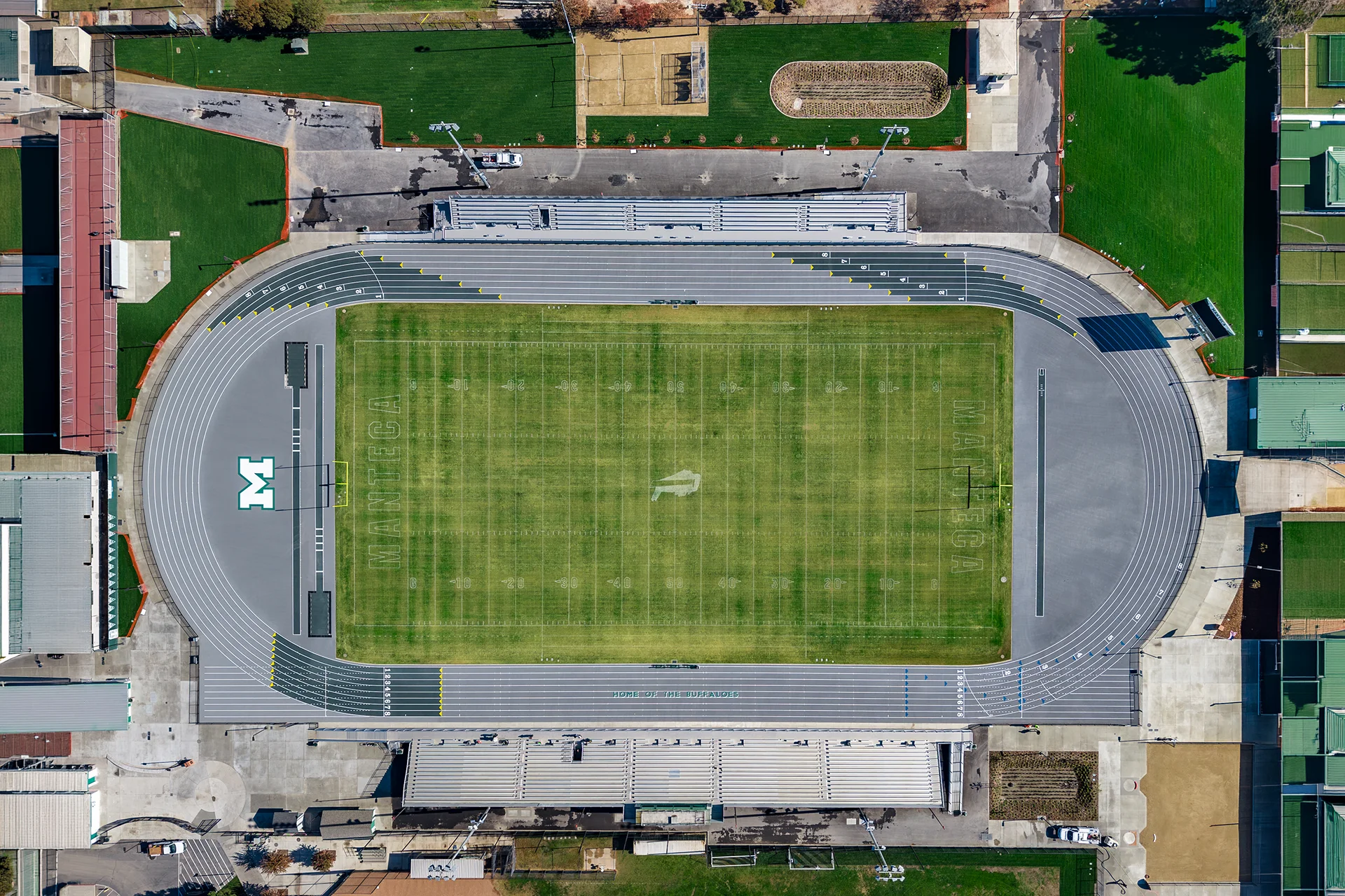 Top-down aerial view of Manteca High School’s football stadium, running track, bleachers, and athletic facilities following the renovation project.