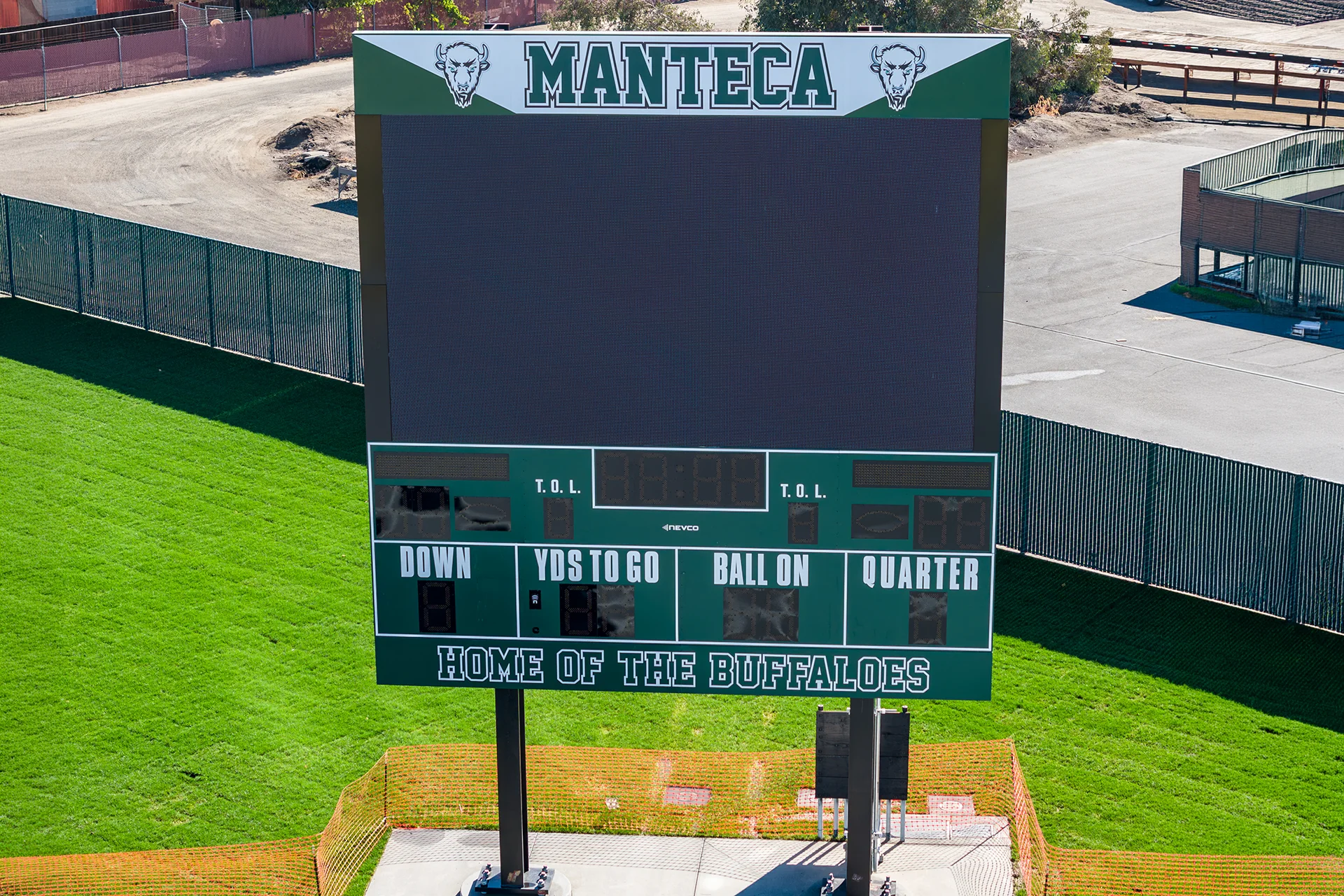 Large digital video scoreboard at Manteca High School’s athletic stadium displaying Buffaloes branding above the football field.