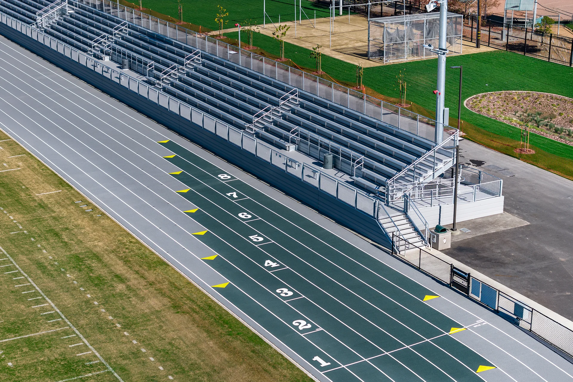 Aerial view of Manteca High School’s running track lanes, spectator bleachers, and accessibility features within the renovated athletic stadium.
