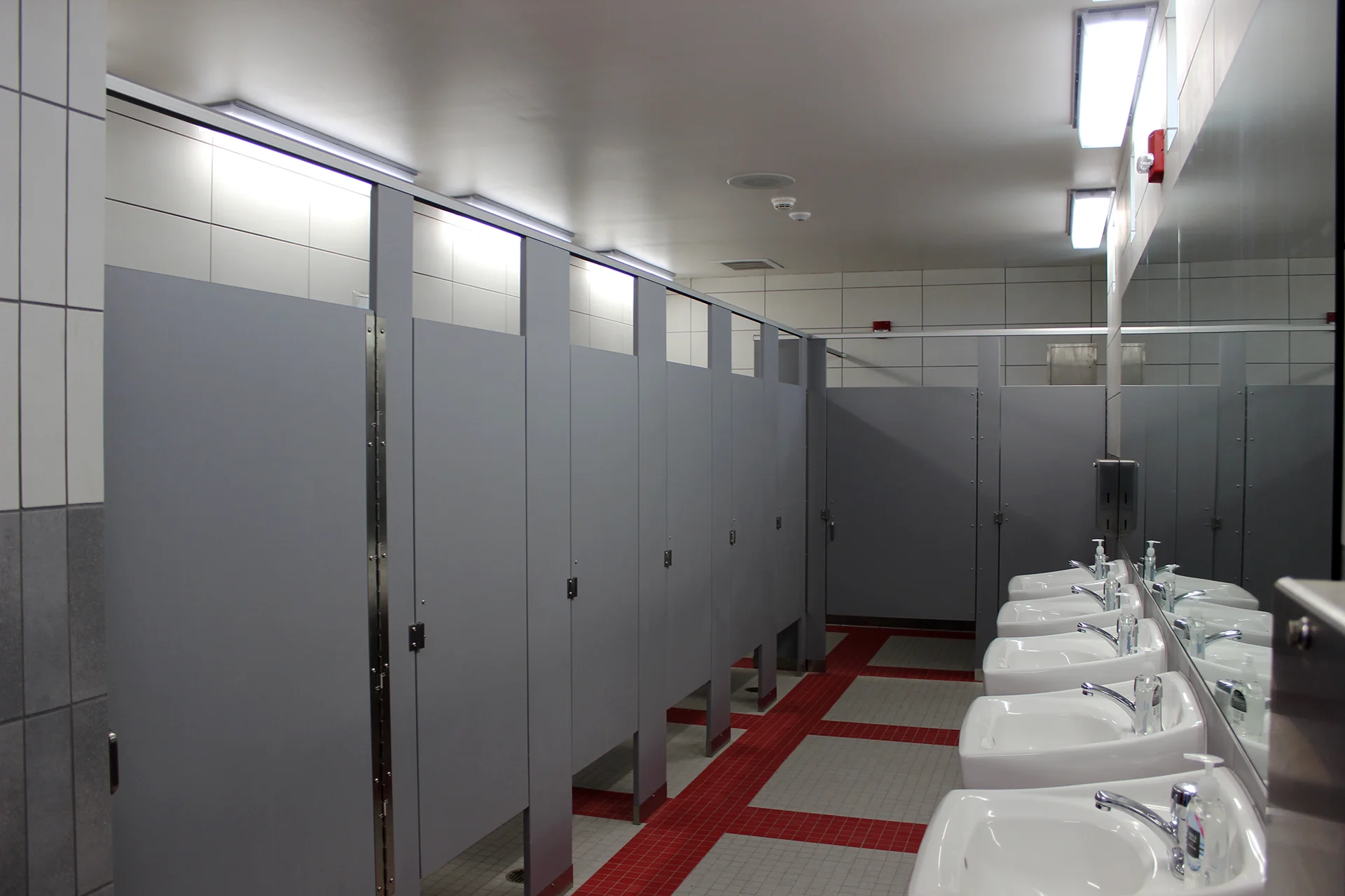 Modern restroom facility at Ripon High School’s athletic complex featuring accessible stalls, sinks, and durable interior finishes.