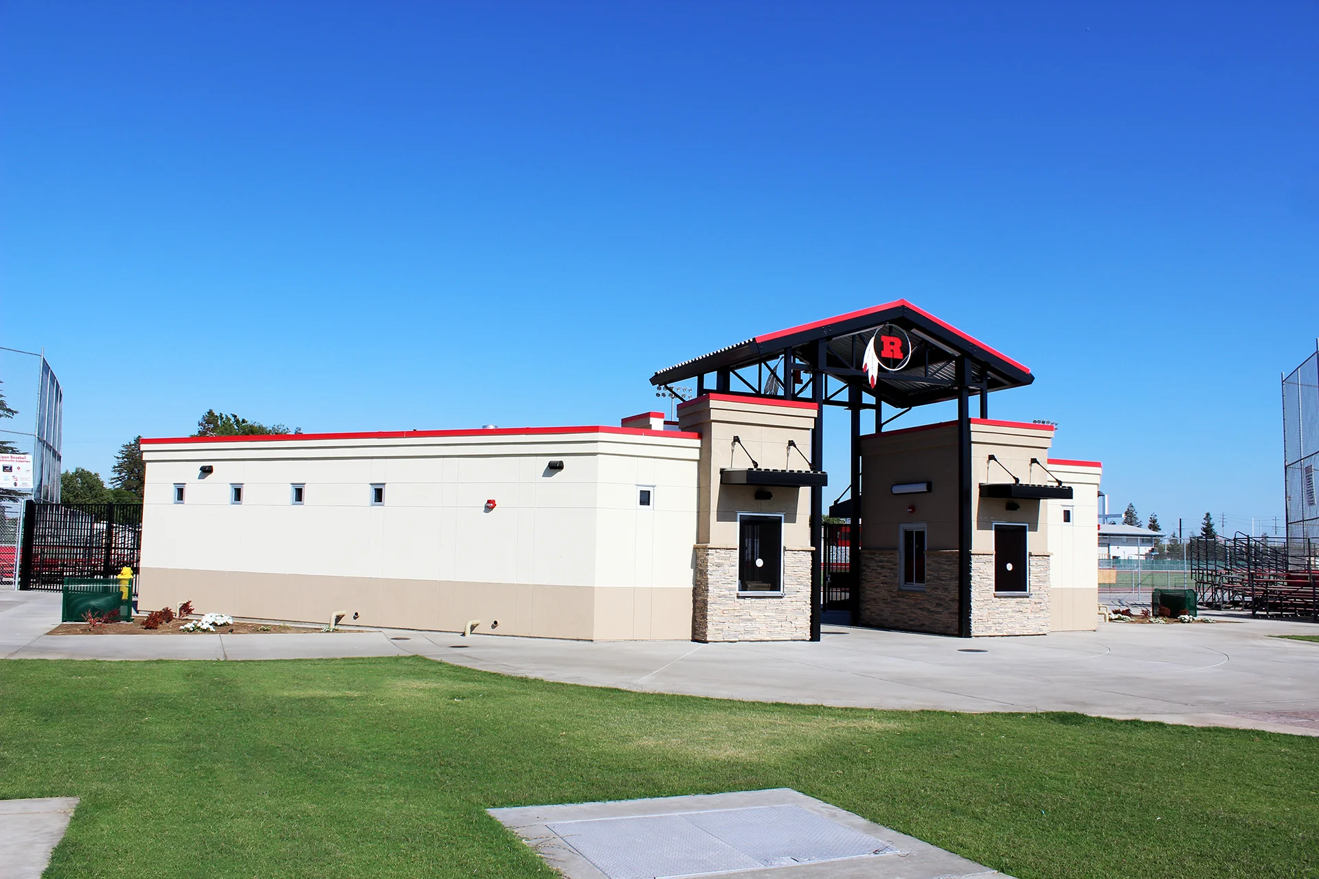Exterior view of the Ripon High School stadium ticket booth and entry structure with school branding and landscaped grounds.