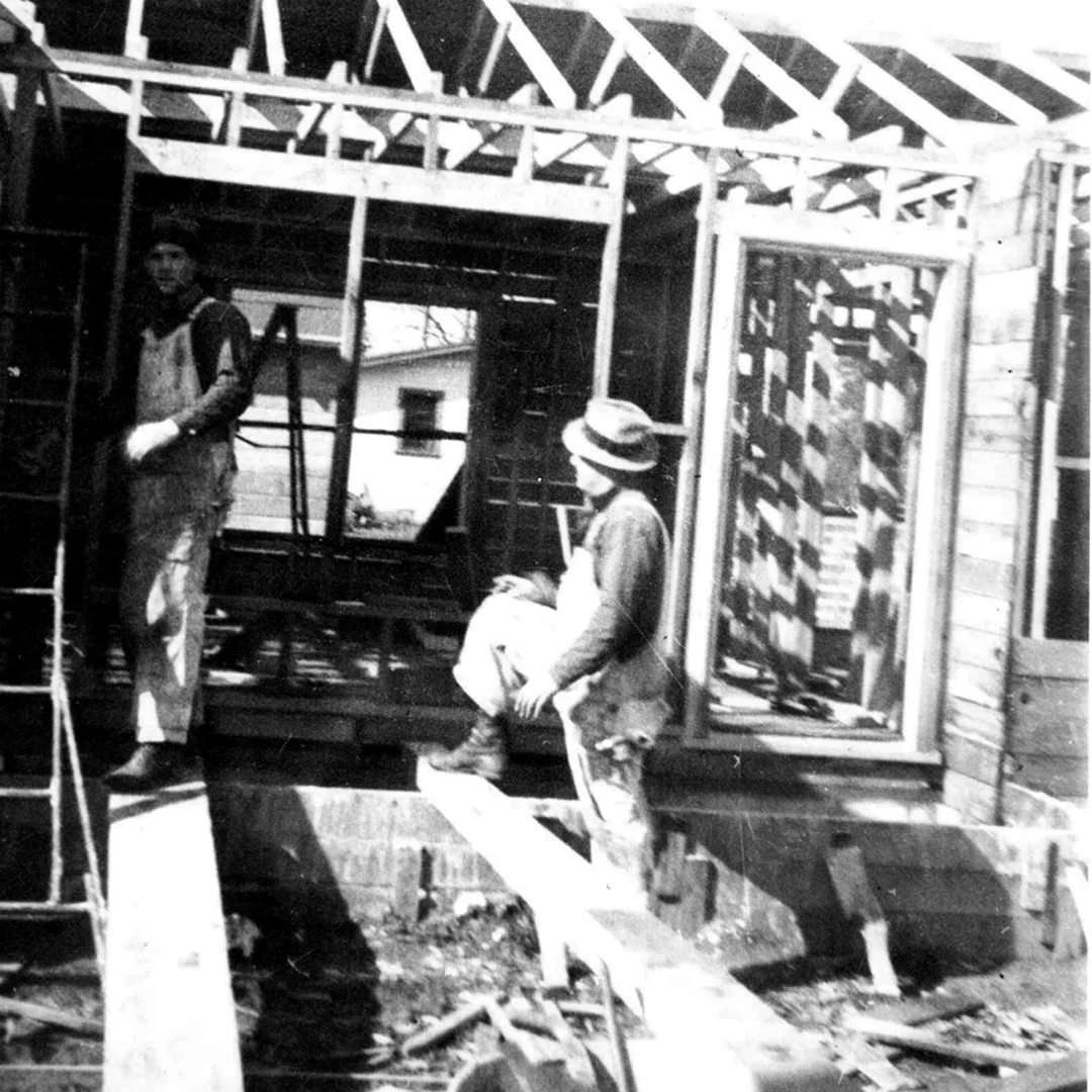 Don Brayton Framing the First C.T. Brayton & Sons Project 1946 Historic black-and-white photograph of Don Brayton framing the first home built by C.T. Brayton & Sons in 1946, marking the company's founding project in Escalon, California.