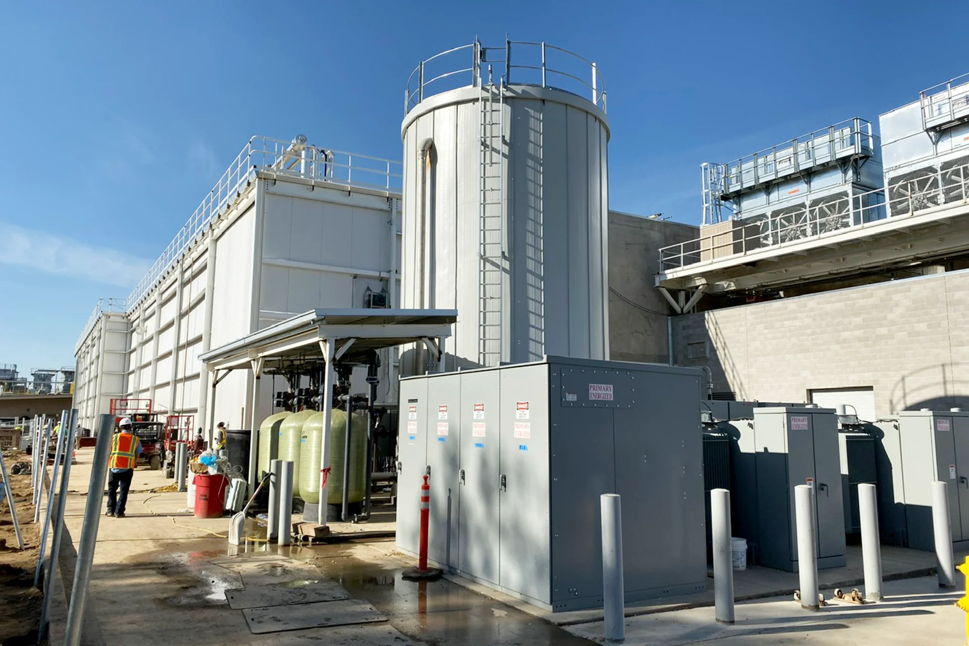 Industrial utility systems installed as part of the Foster Farms Livingston Plant Expansion, featuring process water tanks, cooling equipment, electrical infrastructure, and mechanical support systems.