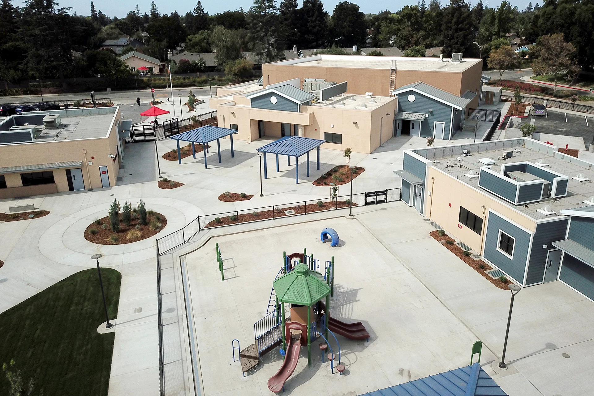Aerial view of Quail Lakes Elementary School featuring the central campus courtyard, playground, outdoor learning spaces, landscaped walkways, and modern classroom buildings.