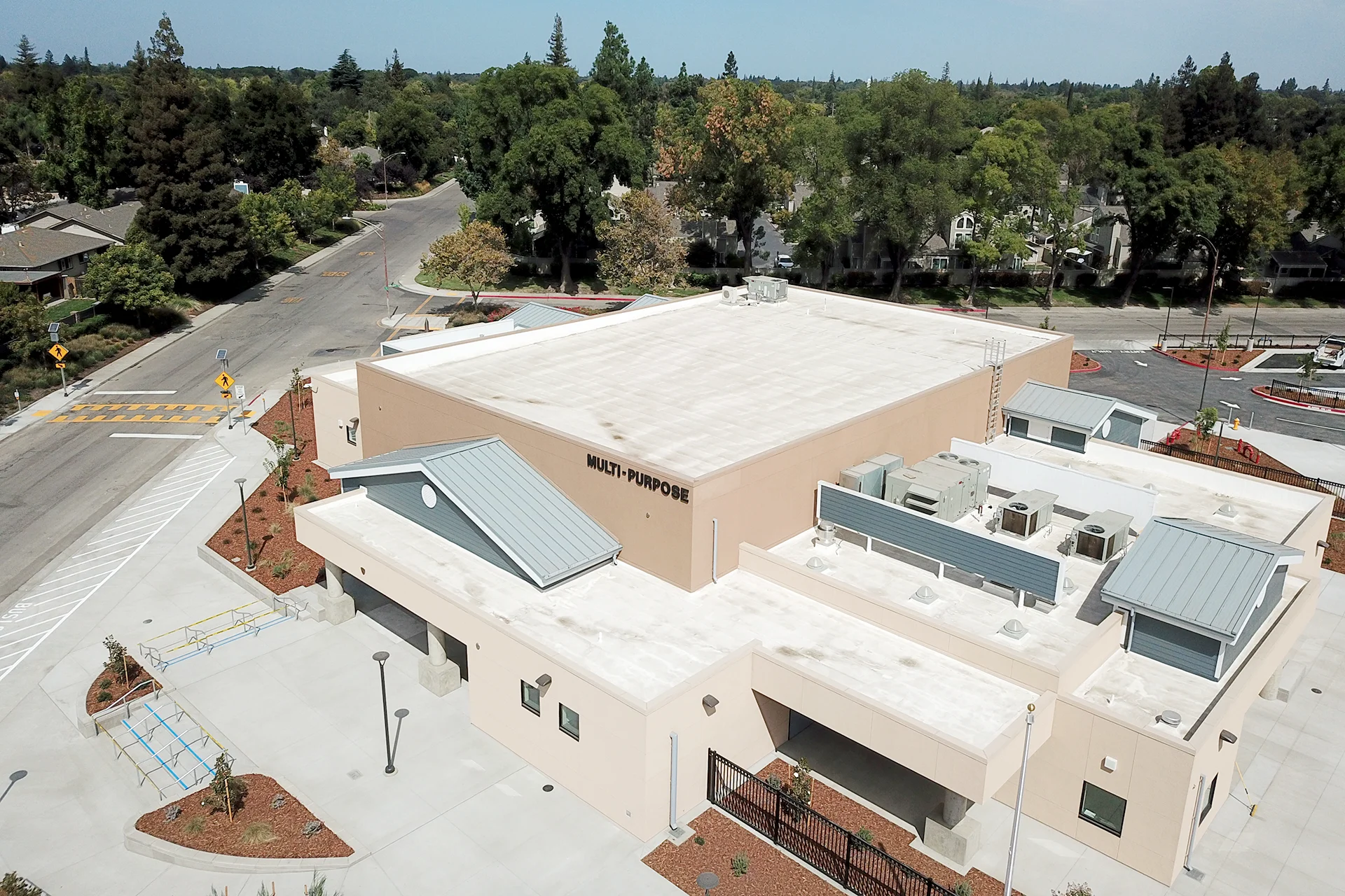 Aerial view of the Quail Lakes Elementary School multi-purpose building featuring modern architecture, campus walkways, accessible entrances, and landscaped school grounds.