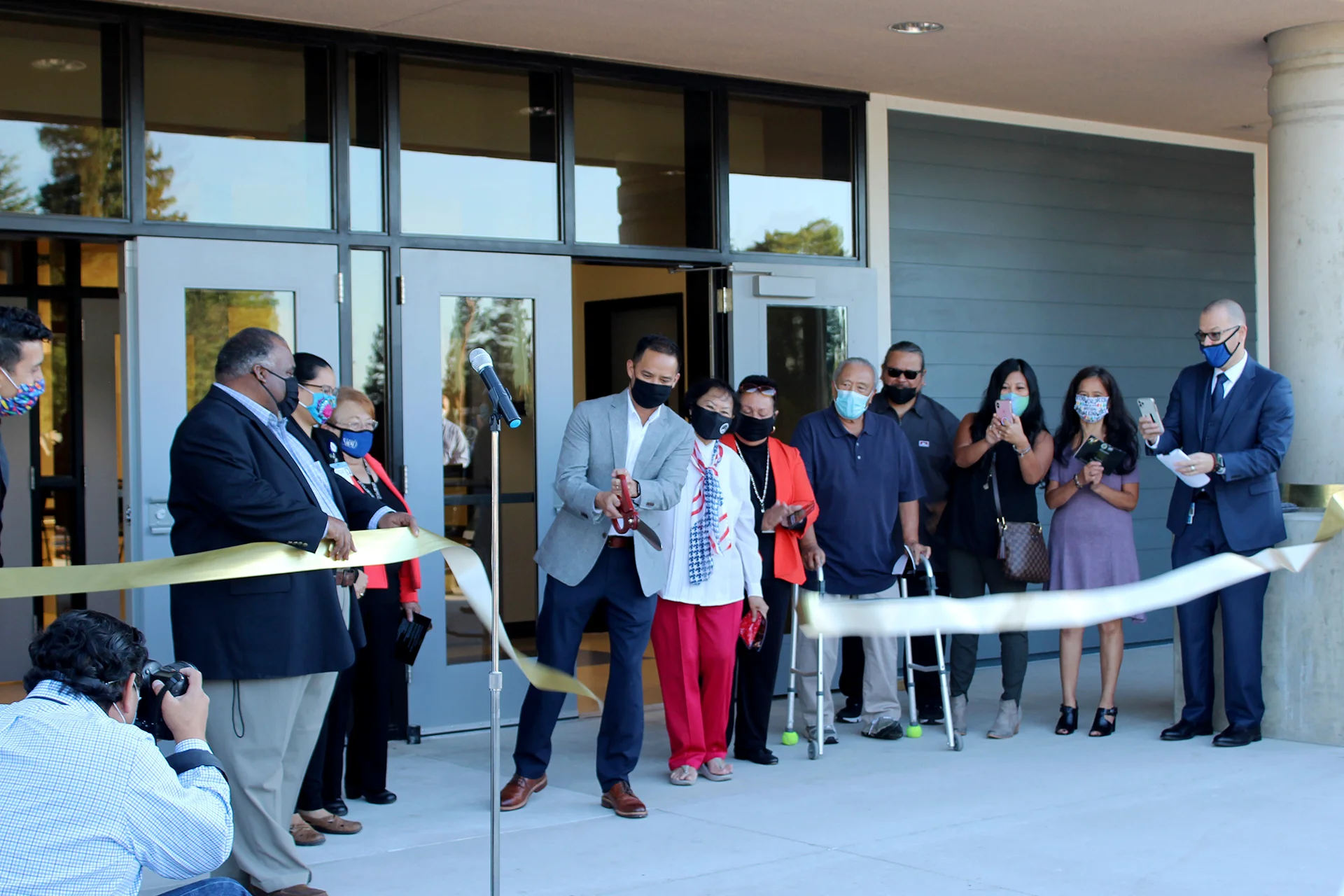 Community leaders, school officials, and guests celebrate the Quail Lakes Elementary School ribbon cutting ceremony during the official campus opening outside the main entrance.
