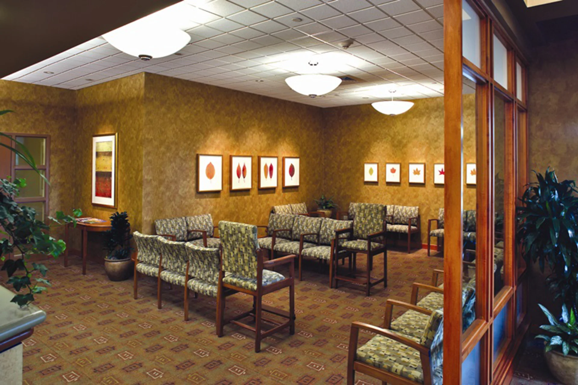 Comfortable patient waiting area inside the Sutter Gould Briggsmore Specialty Center featuring upholstered seating, warm finishes, framed artwork, and a welcoming healthcare environment designed for patient comfort.
