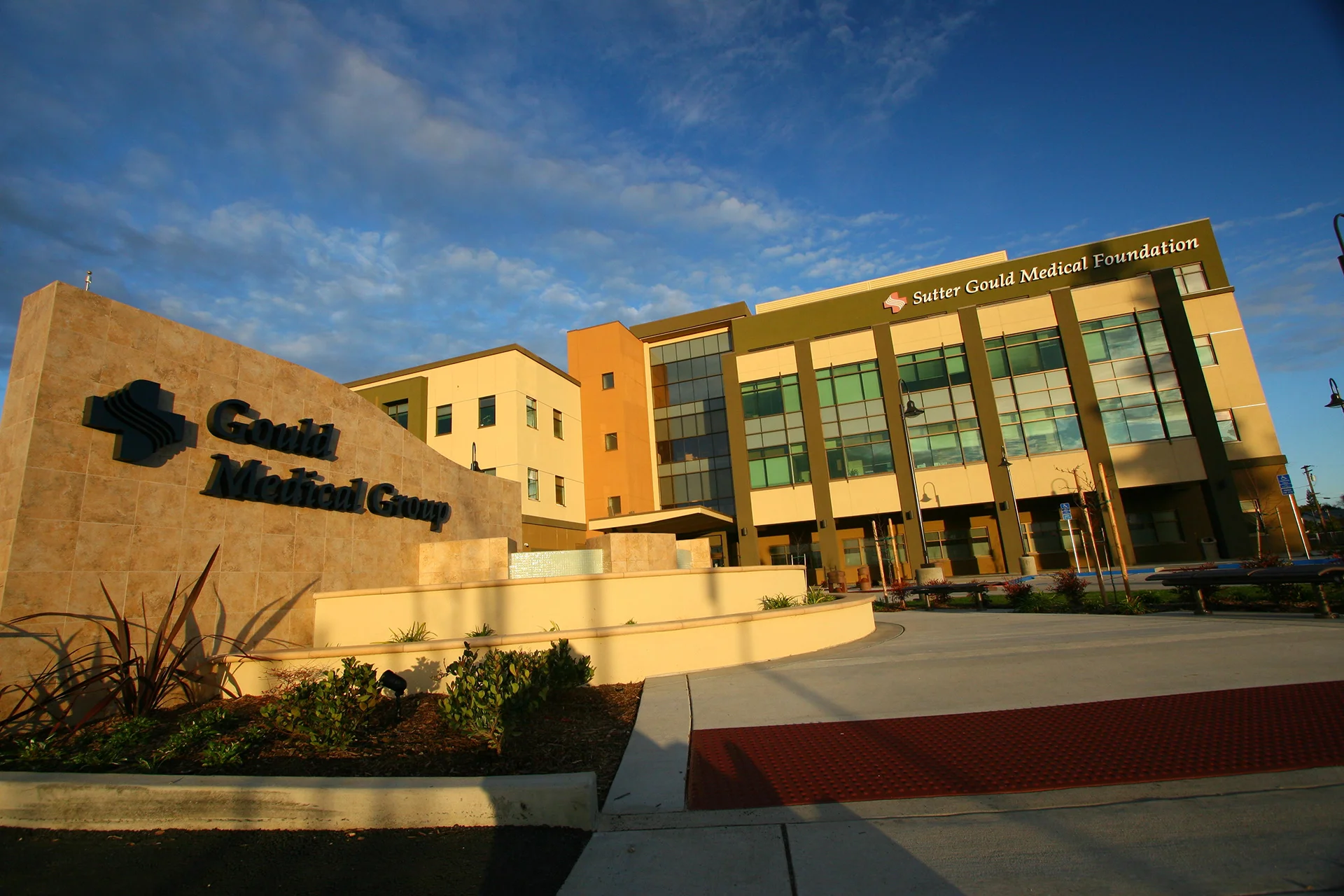 Main entrance and monument sign at the Sutter Gould Medical Foundation medical office on 600 Coffee Road, featuring contemporary healthcare architecture, landscaped patient plaza, and accessible walkways.