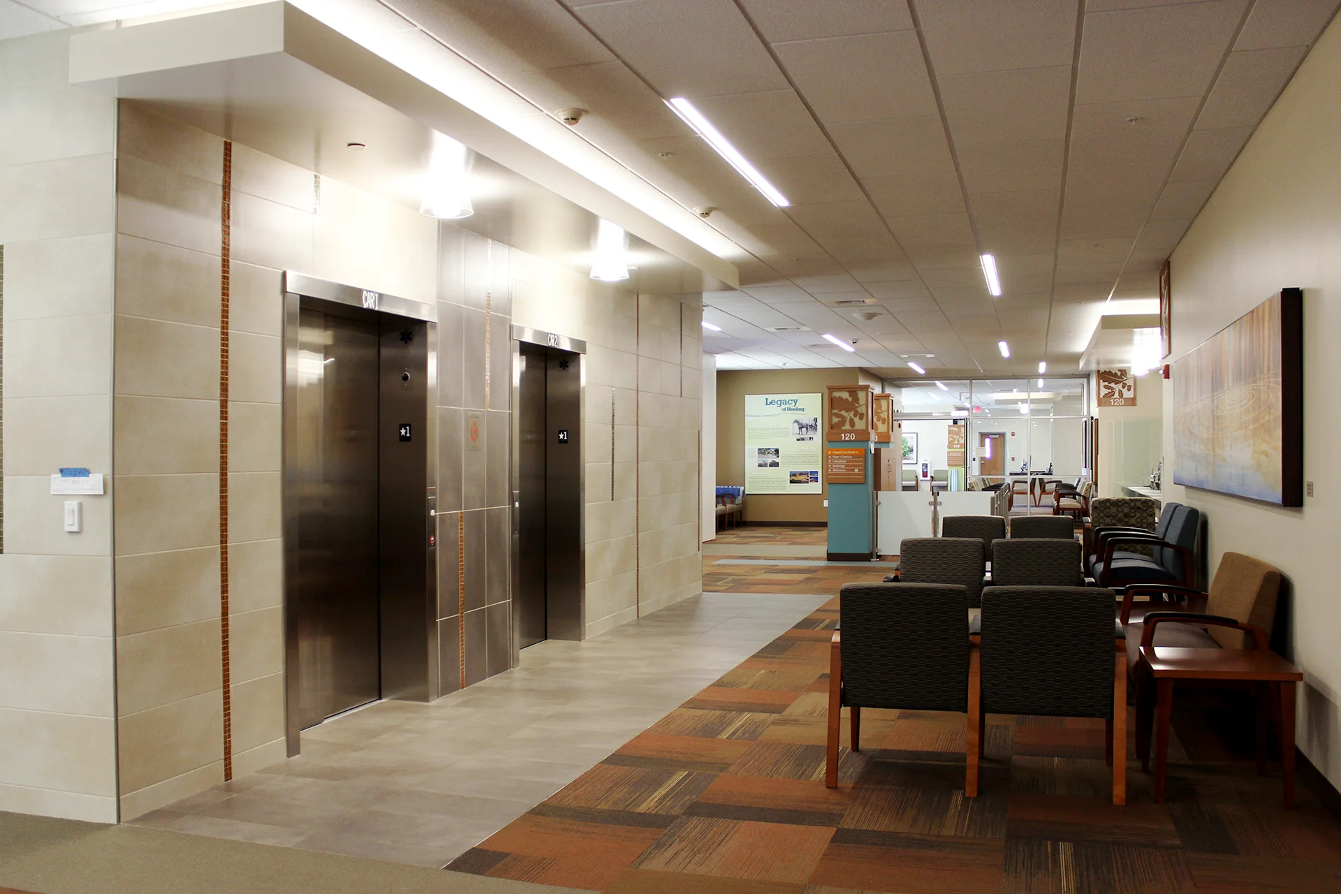 Interior lobby of the Sutter Gould Tracy Medical Office Building featuring elevators, patient seating, clear wayfinding signage, and a spacious, modern healthcare environment designed for patient comfort and accessibility.