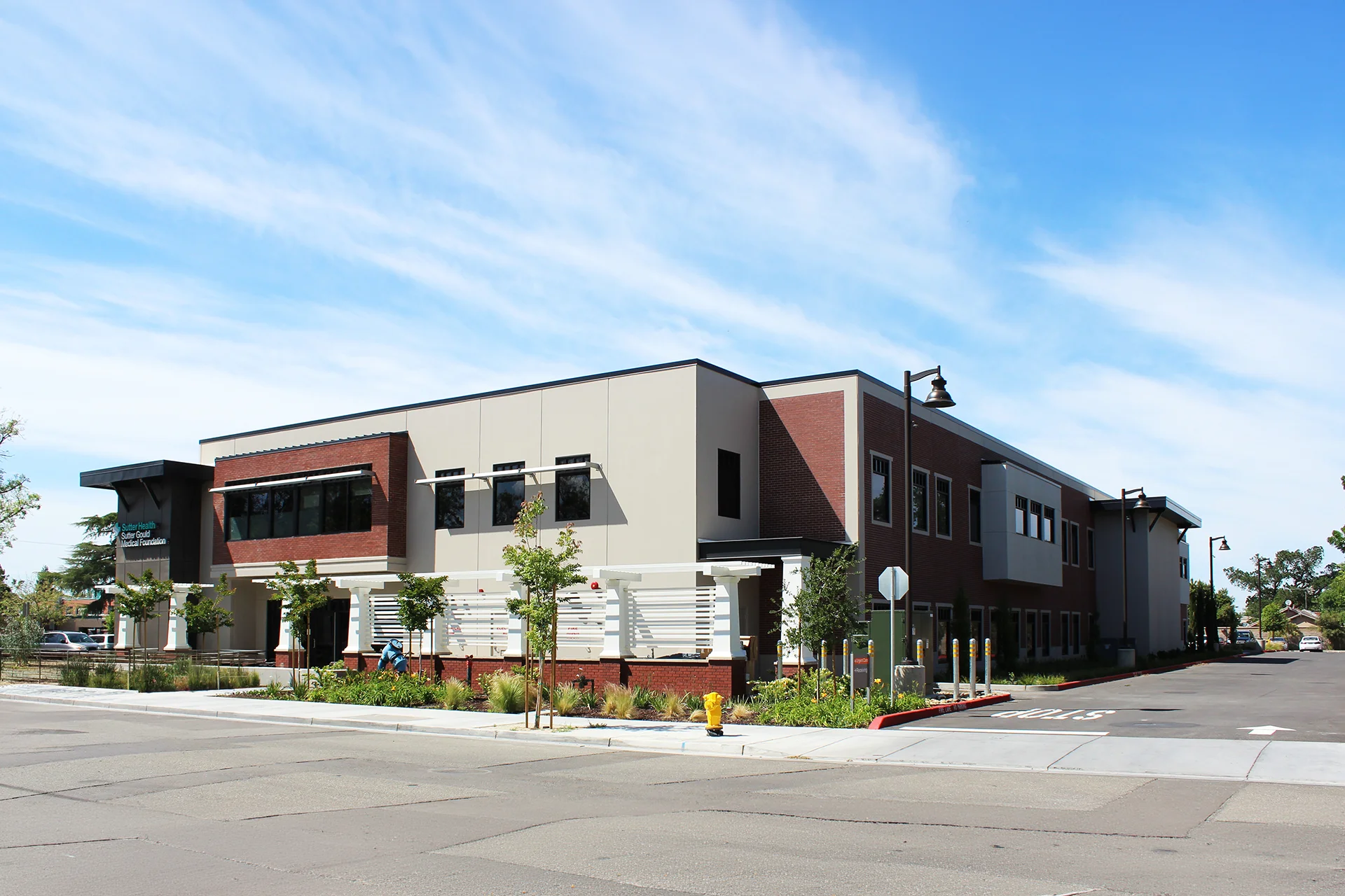 Street-level exterior view of the Sutter Gould Tracy Medical Office Building featuring contemporary medical office architecture, landscaped sidewalks, accessible entrances, and the professionally designed healthcare campus.