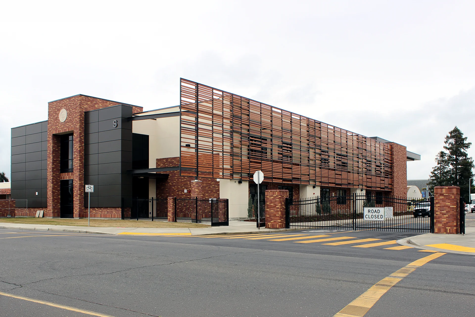 Exterior view of the Turlock High School Science Building featuring contemporary architecture, brick and metal façade, sunshade screening, secure campus entry, and modern STEM education facilities.