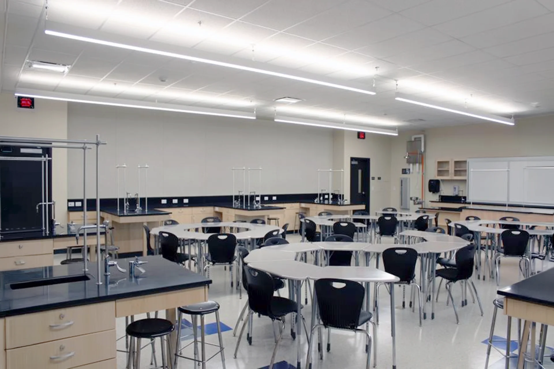 Modern science laboratory classroom at the Turlock High School Science Building featuring collaborative student workstations, lab benches, demonstration stations, and flexible STEM learning space.