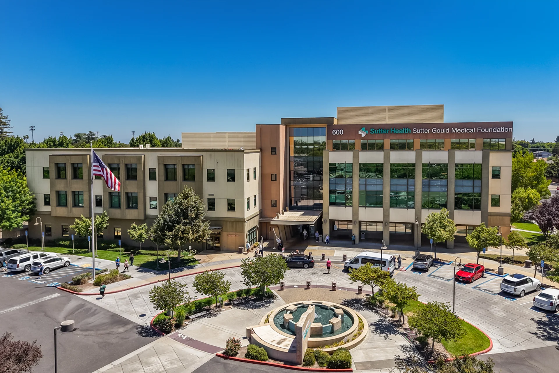 Aerial view of the Sutter Gould Coffee Road Medical Office Building featuring the main entrance, landscaped fountain plaza, patient parking, and the multi-story outpatient healthcare campus in Modesto, California.