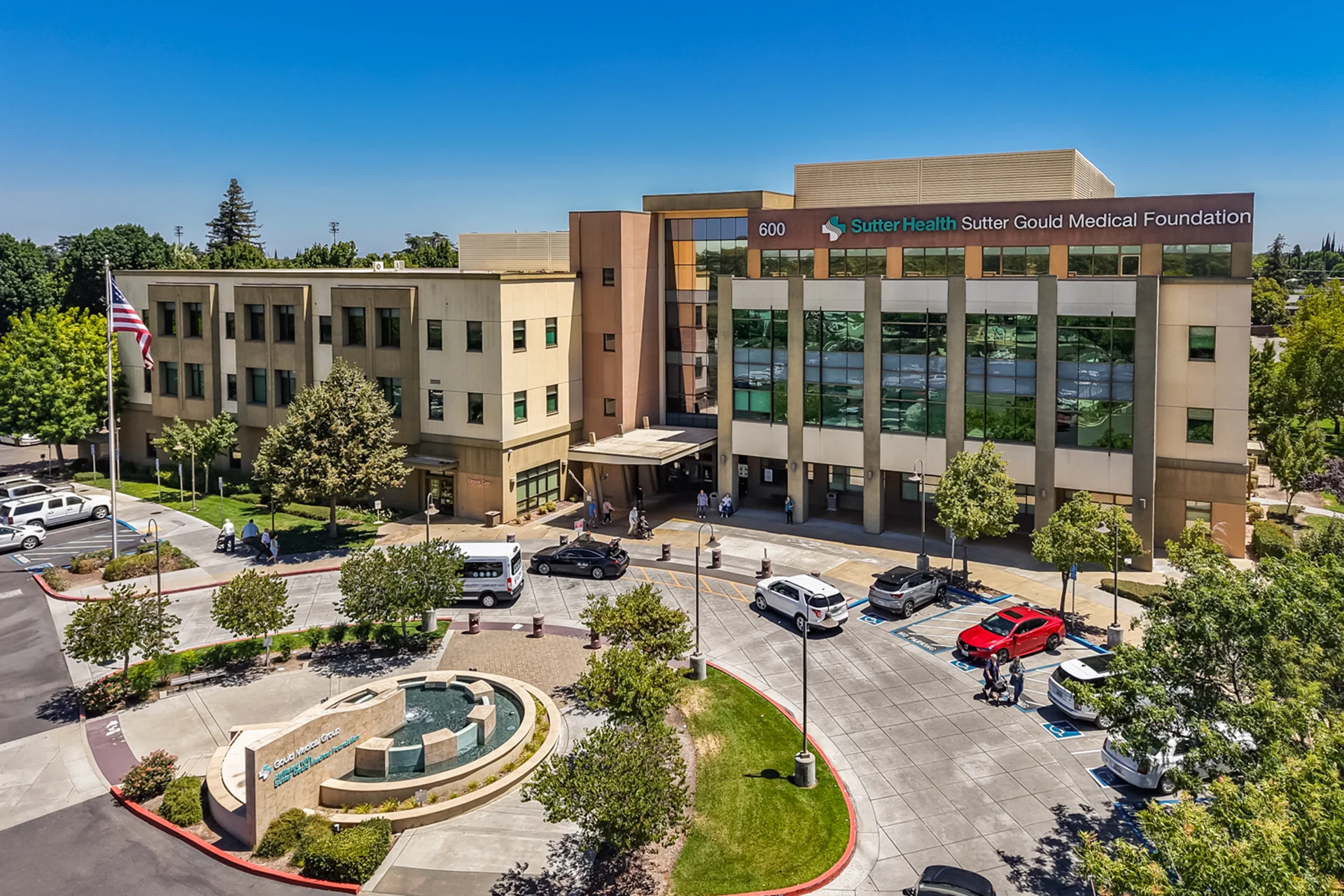 Front elevation of the Sutter Gould Coffee Road Medical Office Building featuring the main entrance, landscaped fountain plaza, patient parking, and contemporary multi-story healthcare campus in Modesto, California.